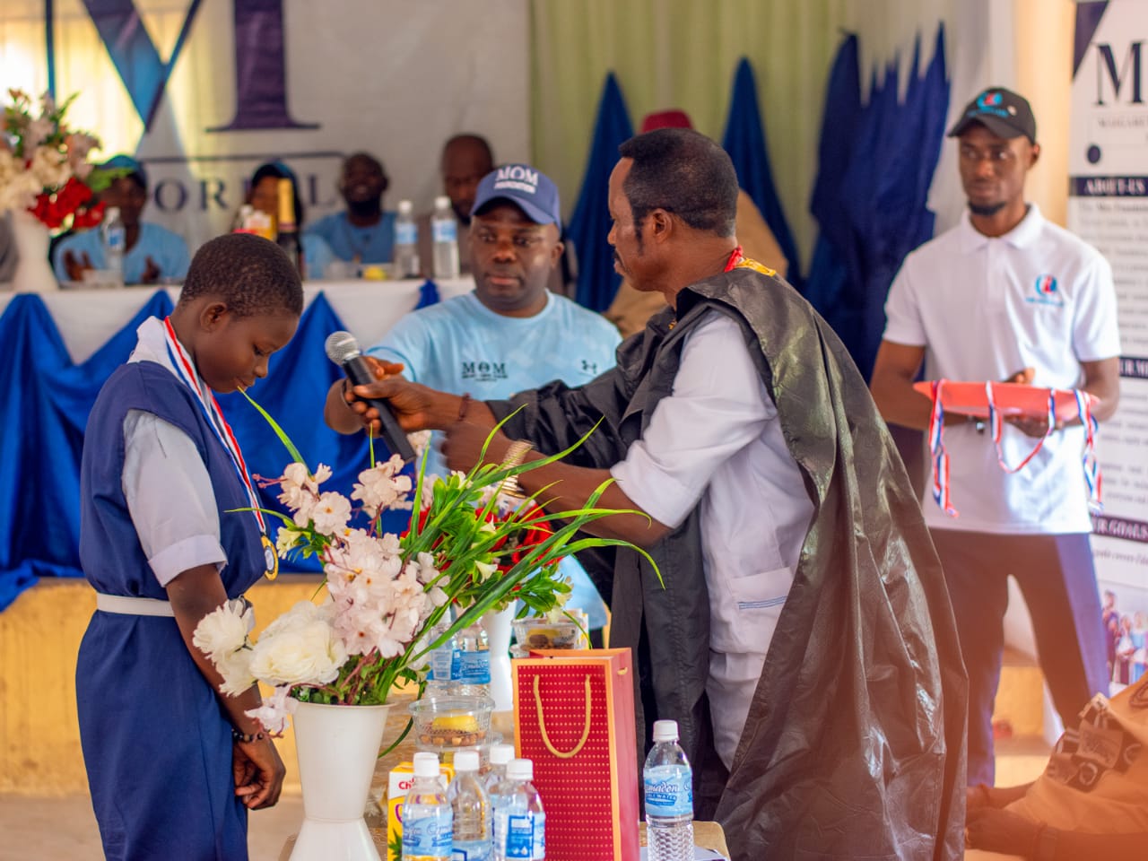The Esama of Abavo Medal Presentation at the 2024 Award Ceremony The Esama of Abavo presenting a medal to one of the outstanding students
